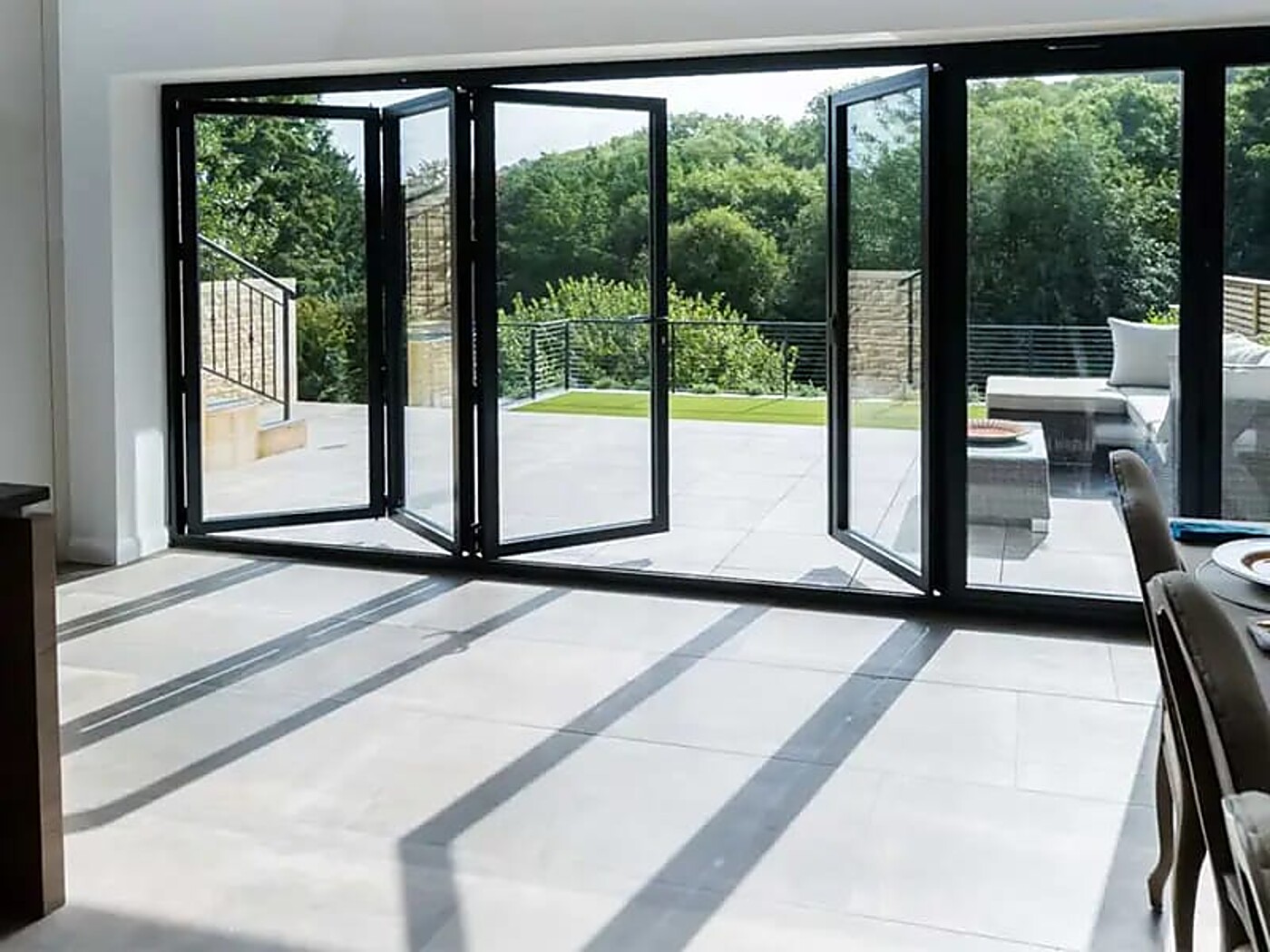 Bi-folding door system open to a patio and garden